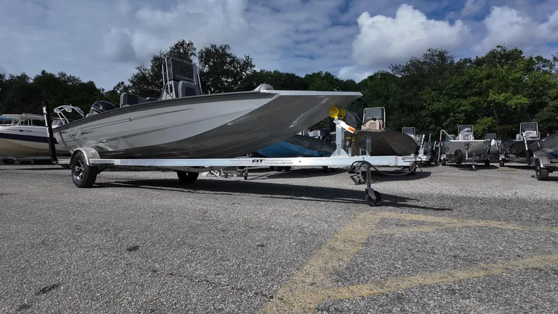 Slide: The Image of 2025 Xpress H20B boat on trailer in parking lot under cloudy sky. - 3