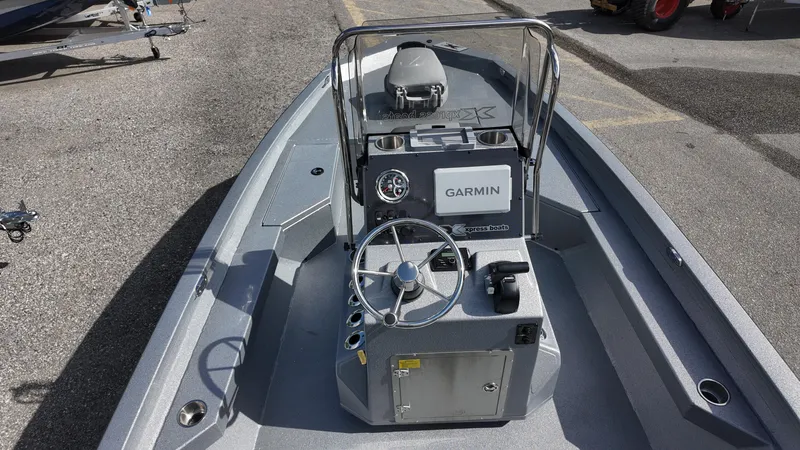 Slide: The Image of 2025 Xpress H20B boat with Garmin navigation system, featuring a sleek console and steering wheel. - 31