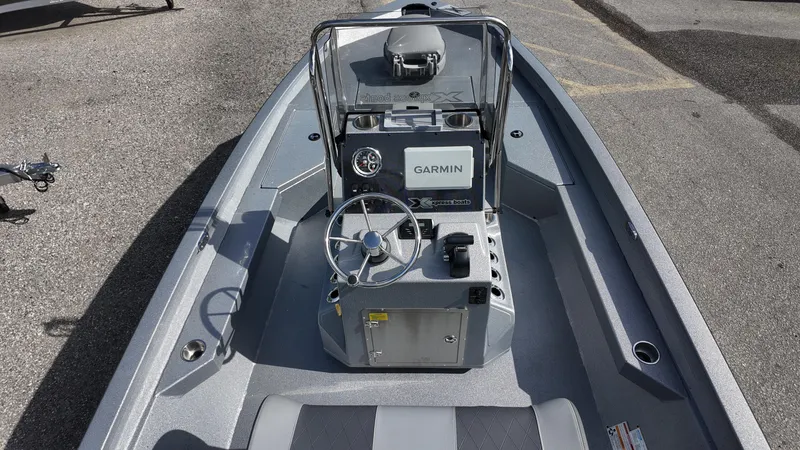 Slide: The Image of 2025 Xpress H20B boat interior with Garmin navigation system and steering wheel. - 32
