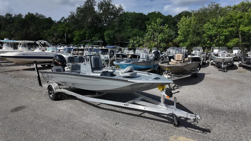 Slide: The Image of 2025 Xpress H20B boat on trailer in a marina with other boats. - 5