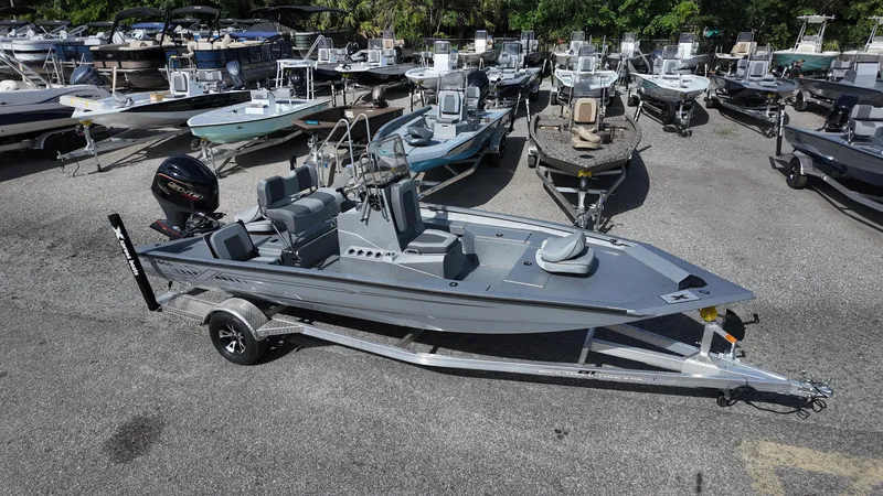 Slide: The Image of 2025 Xpress H20B boat on trailer in a marina with multiple boats. - 8