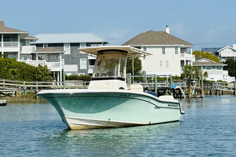 Slide: The Image of 2018 Grady-White Fisherman 216 boat on calm water near coastal homes. - 4