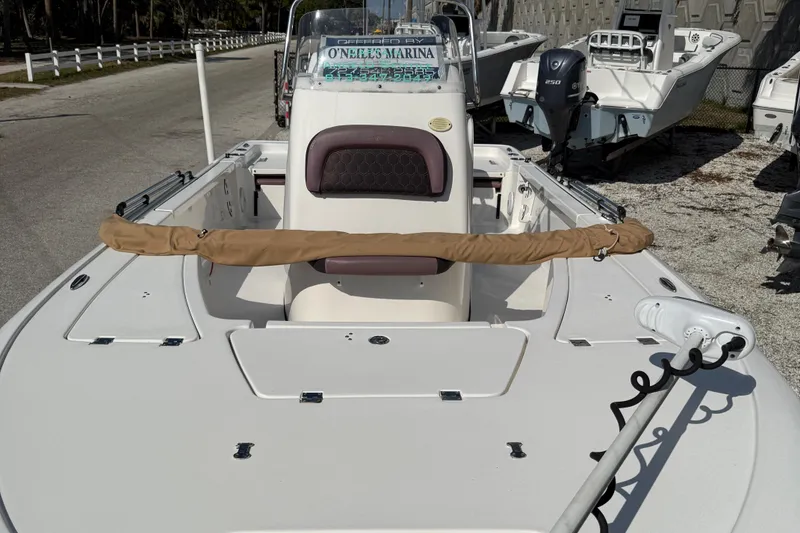 Slide: The Image of 2017 Tidewater 2110 Bay Max boat at marina, featuring spacious deck and console. - 5