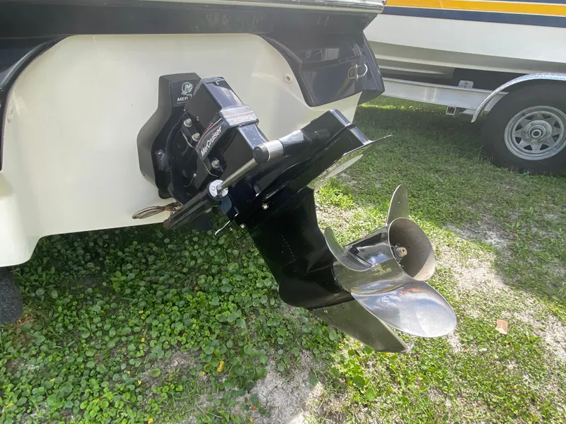 Slide: The Image of 2005 Monterey 194 BR boat propeller and outdrive on grass. - 5