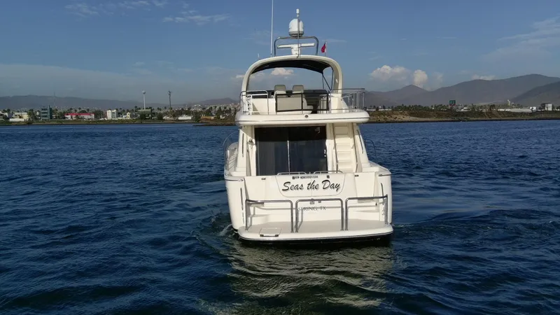 Slide: The Image of 2004 Meridian 580 Pilothouse yacht on open water, clear sky, distant shoreline. - 13