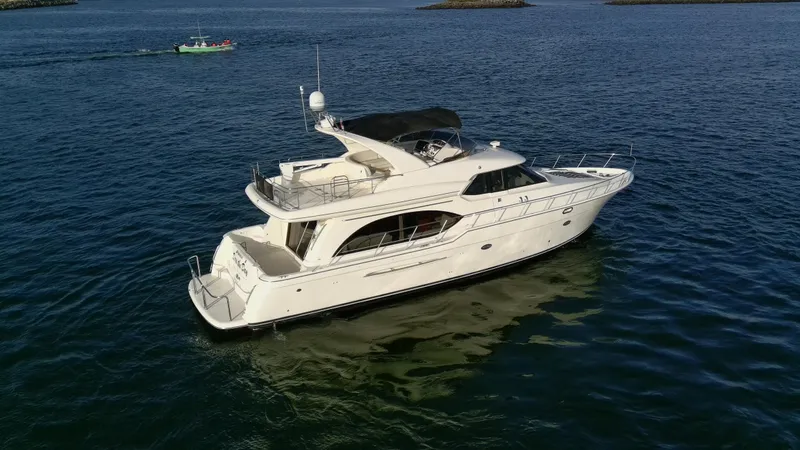 Slide: The Image of 2004 Meridian 580 Pilothouse yacht cruising on open water. - 14