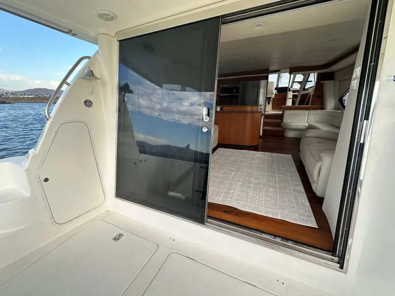 Slide: The Image of 2004 Meridian 580 Pilothouse yacht interior with modern furnishings and scenic water view. - 21
