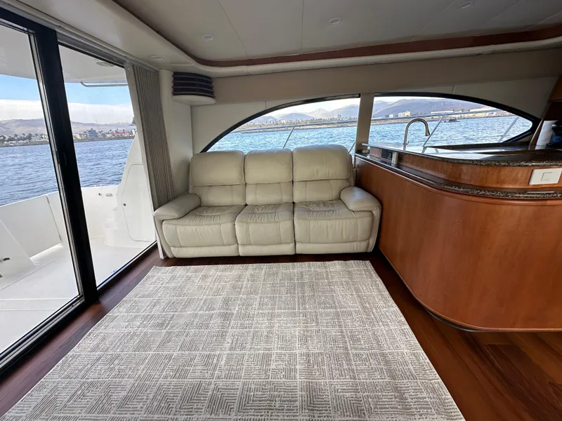 Slide: The Image of Luxurious interior of 2004 Meridian 580 Pilothouse yacht with leather sofa and scenic ocean view. - 28