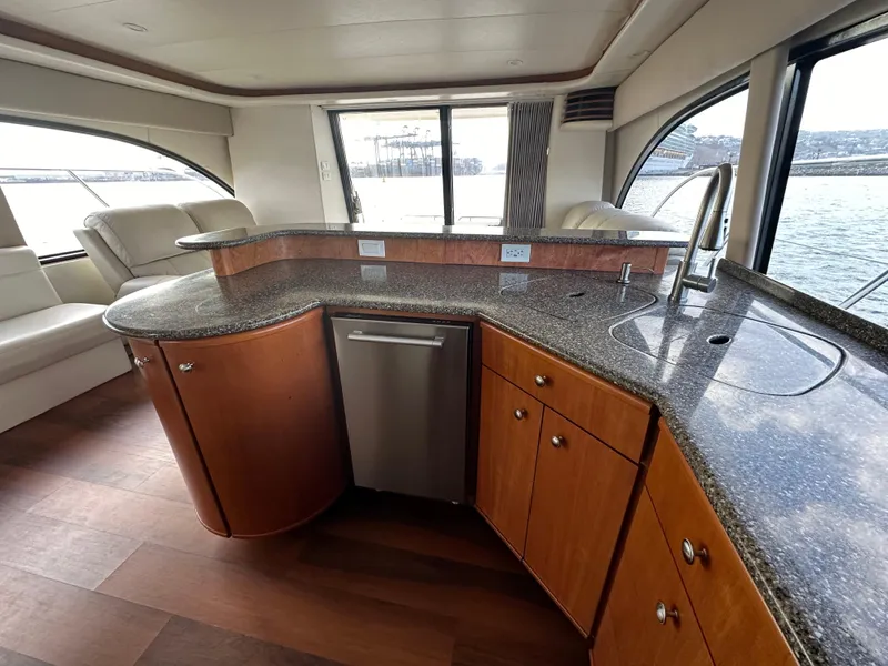 Slide: The Image of Luxurious interior of 2004 Meridian 580 Pilothouse yacht with modern kitchen and scenic windows. - 39