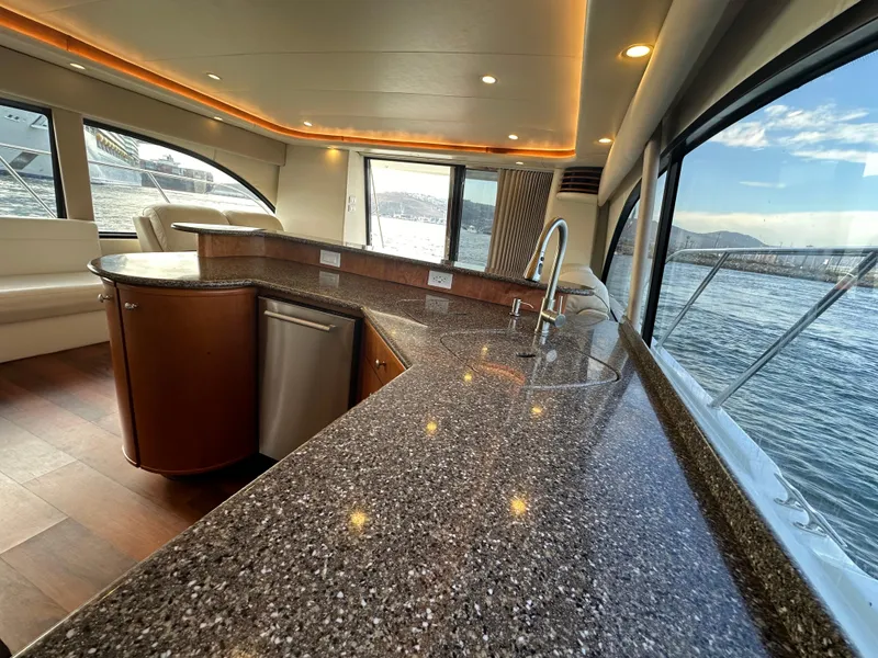 Slide: The Image of Luxurious interior of 2004 Meridian 580 Pilothouse yacht with sleek countertops and panoramic windows. - 40