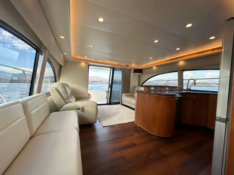 Slide: The Image of Luxurious interior of 2004 Meridian 580 Pilothouse yacht with elegant seating and panoramic windows. - 43