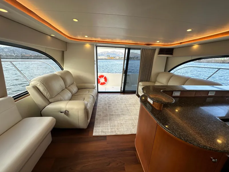 Slide: The Image of Luxurious interior of a 2004 Meridian 580 Pilothouse yacht with leather seating and panoramic windows. - 44