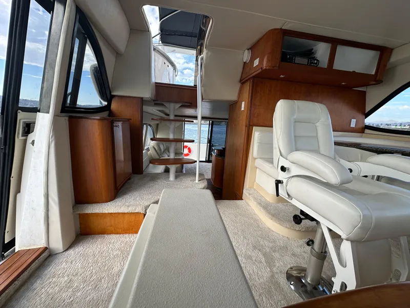 Slide: The Image of Interior of 2004 Meridian 580 Pilothouse yacht with white seating and wooden accents. - 47
