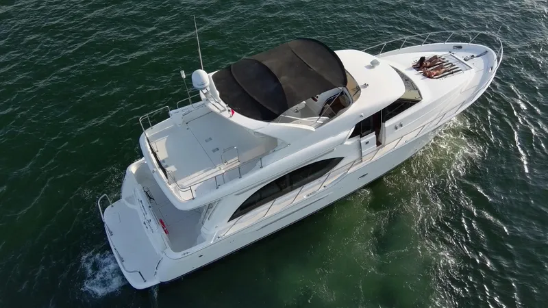 Slide: The Image of 2004 Meridian 580 Pilothouse yacht cruising on open water, aerial view. - 6