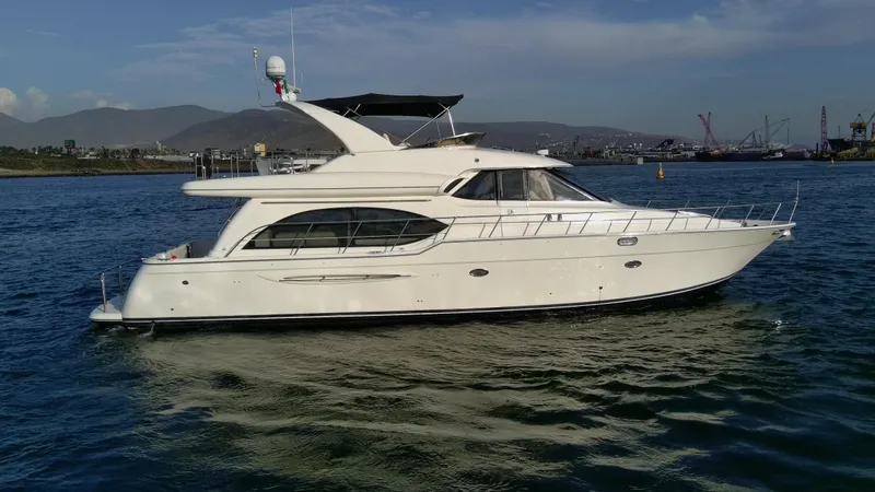 Slide: The Image of 2004 Meridian 580 Pilothouse yacht on calm water with scenic background. - 7