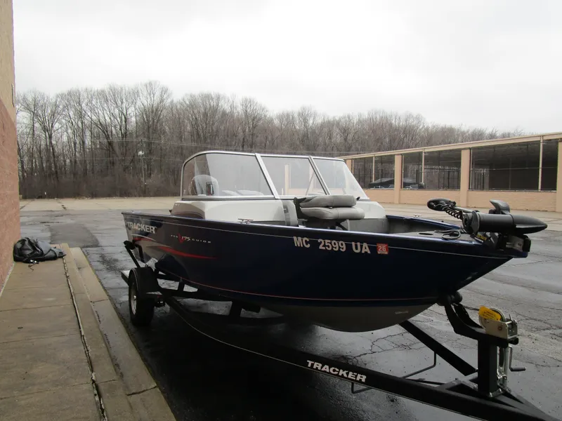 Slide: The Image of 2017 Tracker Pro Guide 175 WT boat on trailer in parking lot. - 2