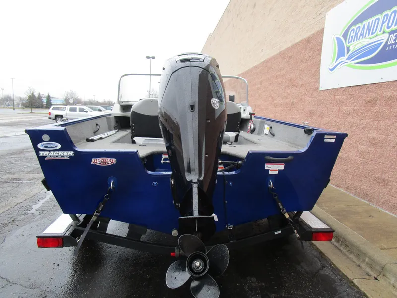 Slide: The Image of 2017 Tracker Pro Guide 175 WT boat, rear view with motor, parked outside dealership. - 4