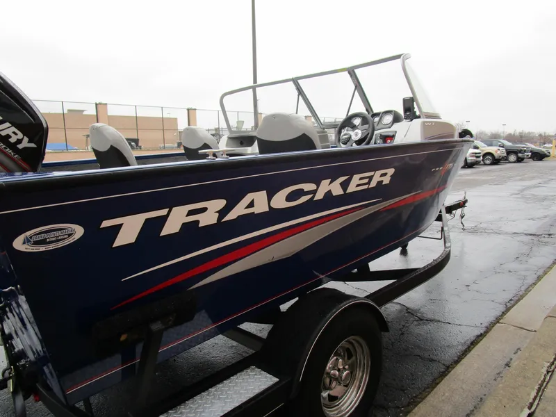 Slide: The Image of 2017 Tracker Pro Guide 175 WT boat on trailer, parked outdoors. - 5