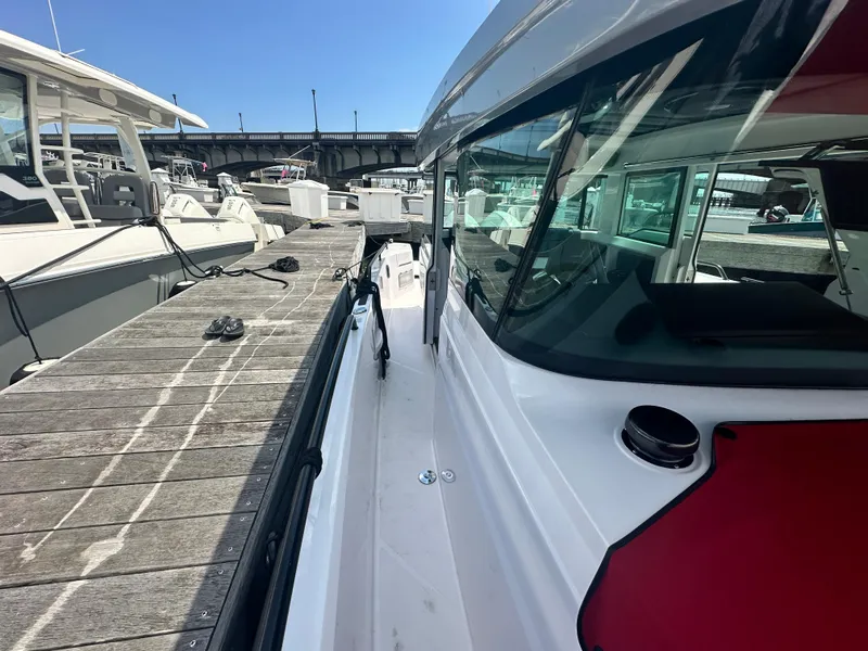 Slide: The Image of 2022 Axopar 37 XC Cross Cabin BRABUS LINE docked at marina, side view. - 11