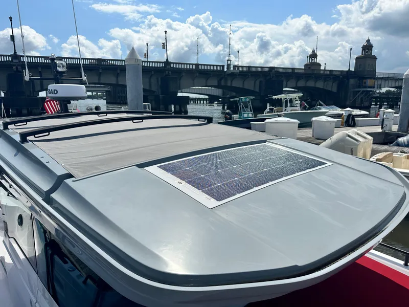 Slide: The Image of 2022 Axopar 37 XC Cross Cabin BRABUS LINE docked near a bridge under a partly cloudy sky. - 14