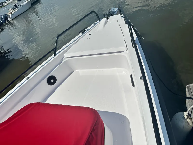 Slide: The Image of 2022 Axopar 37 XC Cross Cabin BRABUS LINE boat with red seating, docked on calm water. - 15