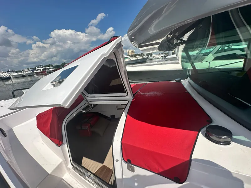 Slide: The Image of Axopar 37 XC Cross Cabin BRABUS LINE 2022 with red accents, docked under a blue sky. - 20