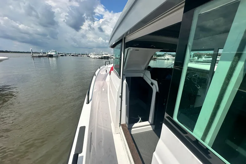 Slide: The Image of 2022 Axopar 37 XC CROSS CABIN boat docked, showcasing sleek design and spacious cabin. - 22