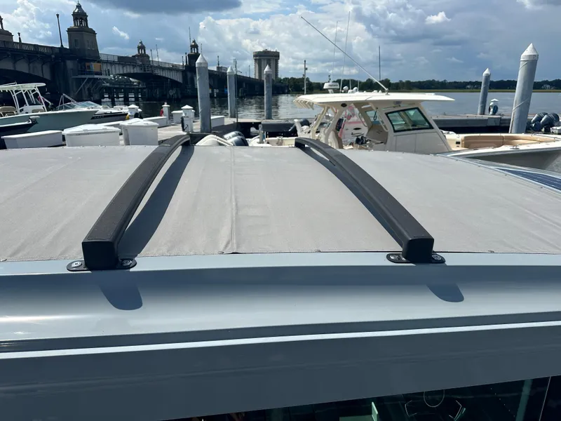 Slide: The Image of Axopar 37 XC Cross Cabin BRABUS LINE 2022 roof with bridge and boats in background. - 23