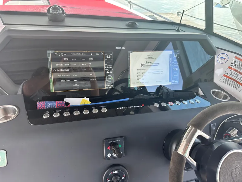 Slide: The Image of Dashboard of 2022 Axopar 37 XC Cross Cabin BRABUS LINE with navigation screens and controls. - 27