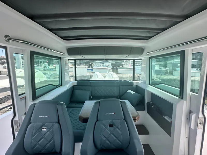 Slide: The Image of Interior of 2022 Axopar 37 XC Cross Cabin BRABUS LINE, featuring luxurious seating and panoramic windows. - 30