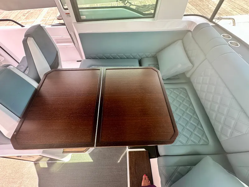 Slide: The Image of Luxurious interior of 2022 Axopar 37 XC Cross Cabin BRABUS LINE with elegant seating and wooden table. - 36