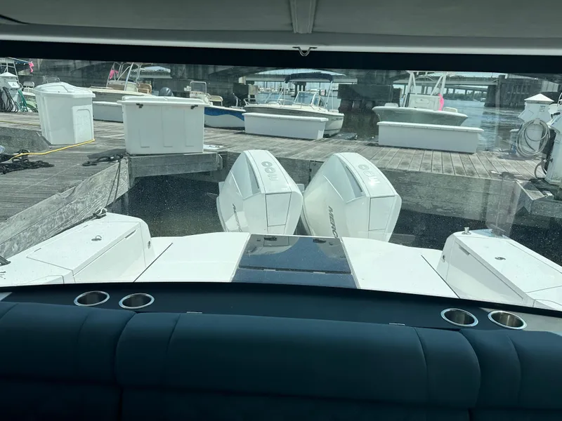 Slide: The Image of 2022 Axopar 37 XC Cross Cabin BRABUS LINE with dual engines at a marina dock. - 38