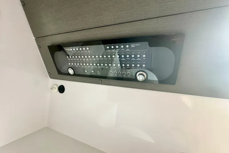 Slide: The Image of Control panel inside 2022 Axopar 37 XC CROSS CABIN boat, featuring various switches and dials. - 42