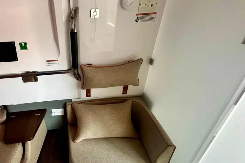 Slide: The Image of Interior of 2022 Axopar 37 XC CROSS CABIN with beige seating and modern design elements. - 46