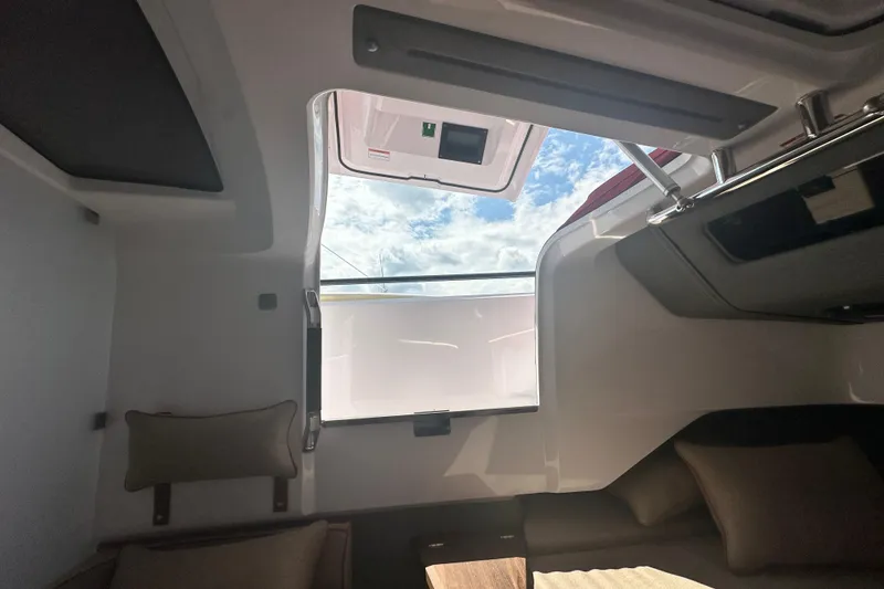 Slide: The Image of Interior view of 2022 Axopar 37 XC CROSS CABIN with open roof hatch and cushions. - 47