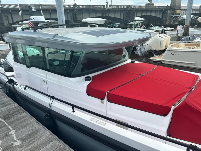 Slide: The Image of 2022 Axopar 37 XC Cross Cabin BRABUS LINE with red cover docked at marina. - 7