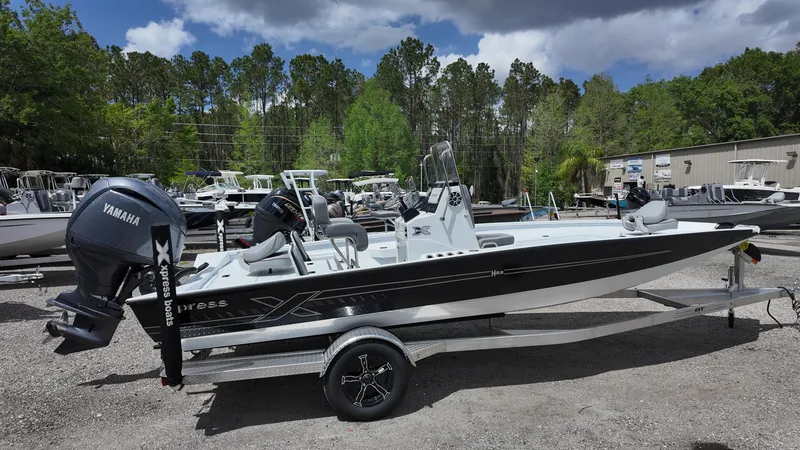 Slide: The Image of 2025 Xpress H22B boat with Yamaha engine on trailer, parked outdoors. - 10