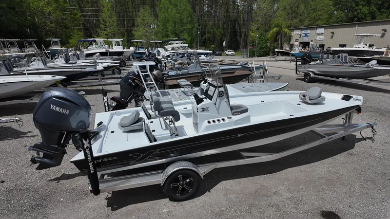 Slide: The Image of 2025 Xpress H22B boat with Yamaha engine on a trailer in a boatyard. - 11