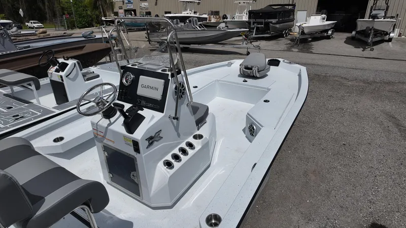 Slide: The Image of 2025 Xpress H22B boat with Garmin system, docked outdoors. - 16