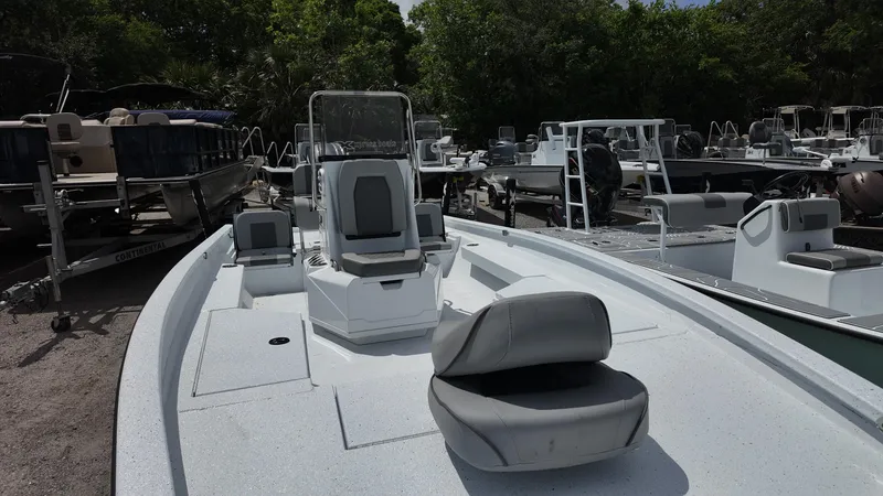 Slide: The Image of 2025 Xpress H22B boat with seating, displayed outdoors among other boats. - 22