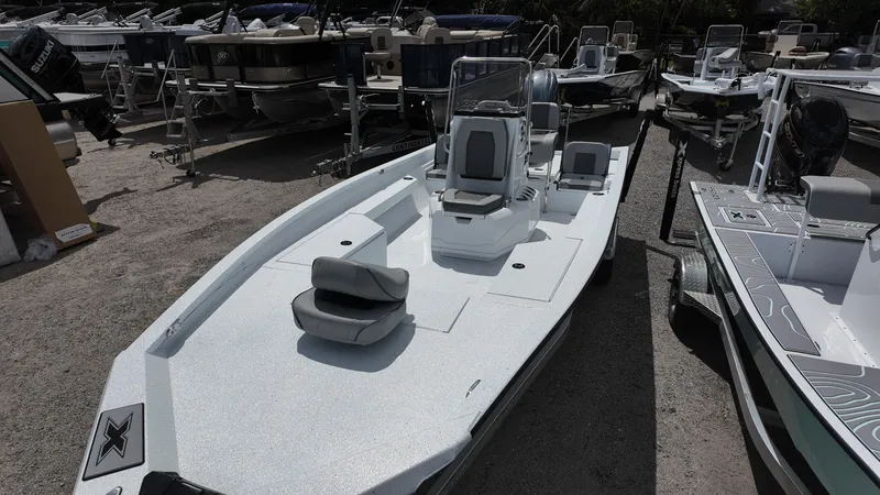 Slide: The Image of 2025 Xpress H22B boat with sleek design, parked among other boats. - 23