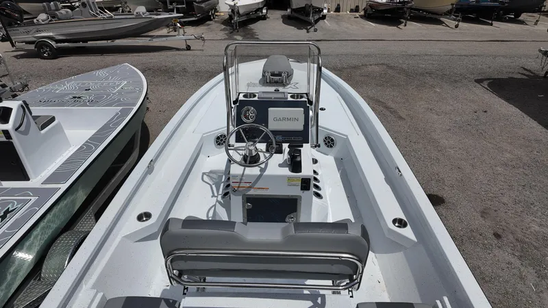 Slide: The Image of 2025 Xpress H22B boat interior with Garmin navigation system, steering wheel, and seating. - 29