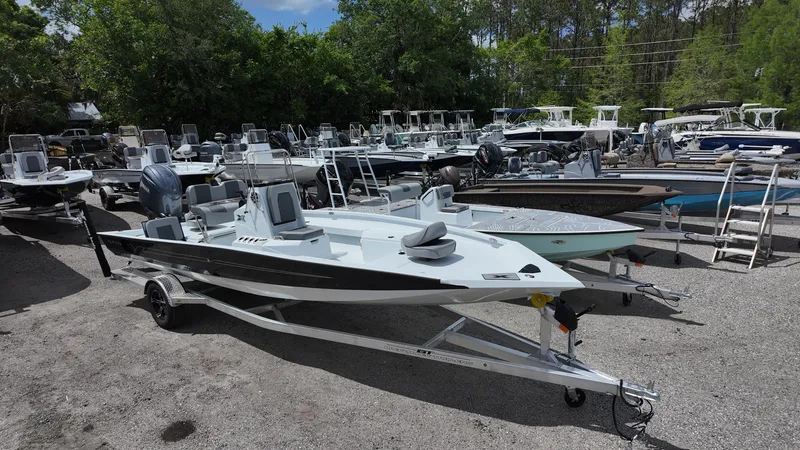 Slide: The Image of 2025 Xpress H22B boat on trailer, surrounded by other boats in outdoor lot. - 3