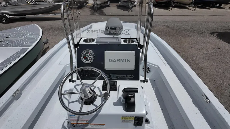 Slide: The Image of 2025 Xpress H22B boat dashboard with Garmin navigation system and steering wheel. - 30