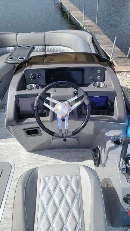 Slide: The Image of 2025 Bennington R Bowrider Swingback 24 RTSB dashboard with modern steering and controls. - 25