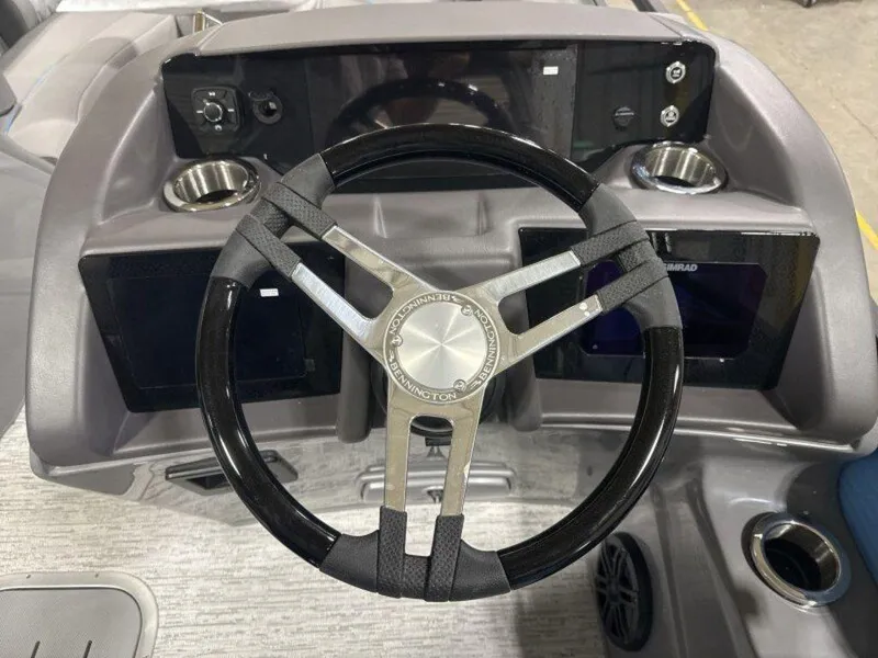 Slide: The Image of Steering wheel of 2025 Bennington R Bowrider Swingback 24 RTSB with modern dashboard features. - 6