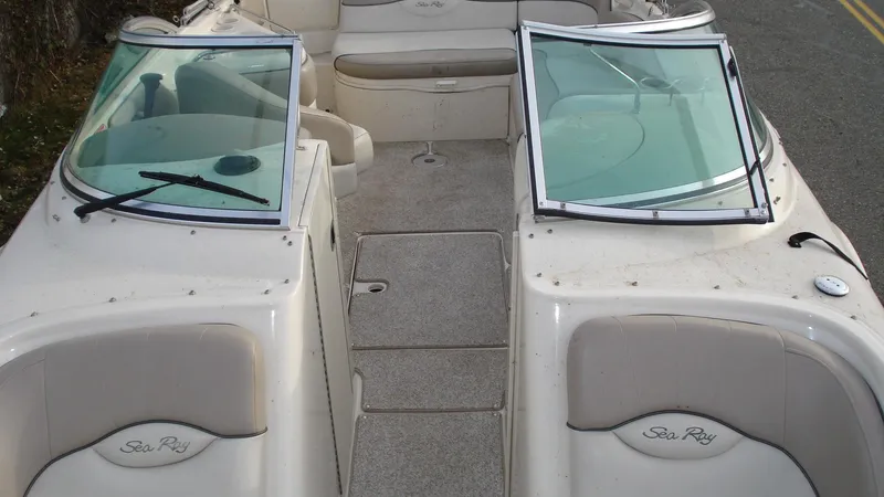 Slide: The Image of 2003 Sea Ray 240 Sundeck boat interior with open windshield and seating area. - 11