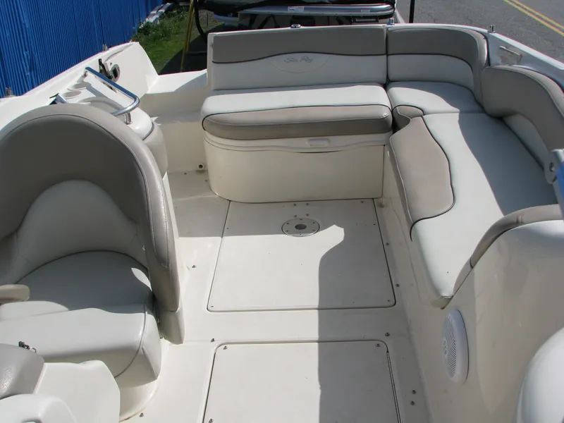 Slide: The Image of 2003 Sea Ray 240 Sundeck interior with spacious seating and white upholstery. - 13