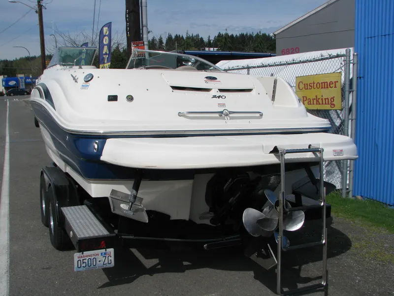 Slide: The Image of 2003 Sea Ray 240 Sundeck boat on trailer, parked near customer parking area. - 4