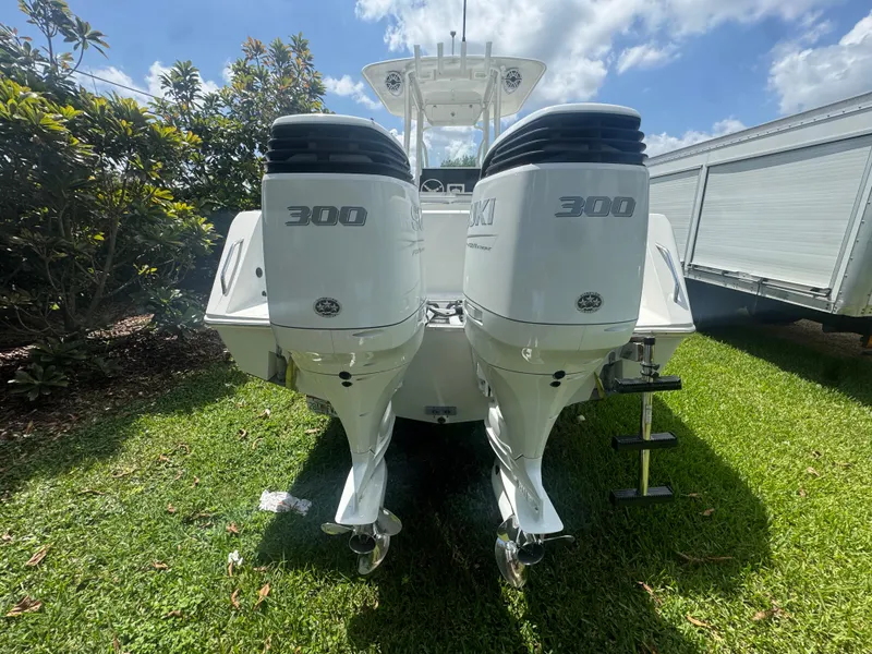 Slide: The Image of 1997 Stamas 290 Tarpon boat with twin 300 horsepower engines on grass. - 10